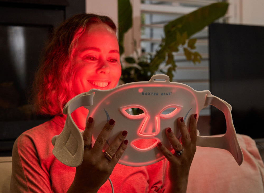 Baxter_Blue_Red_Light_Therapy_Face_Mask_smiling woman holding mask