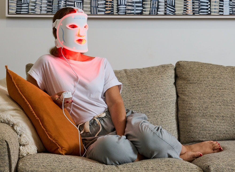 Baxter_Blue_Red_Light_Therapy_Face_Mask_woman on couch