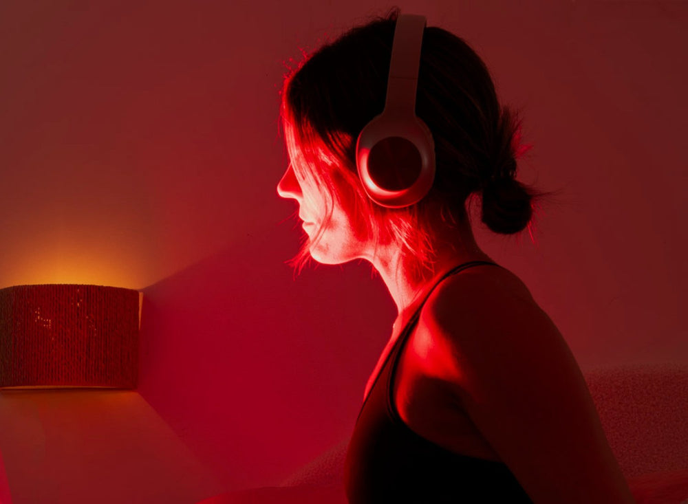 Baxter Blue Red Light Therapy Max Woman using it with headphones