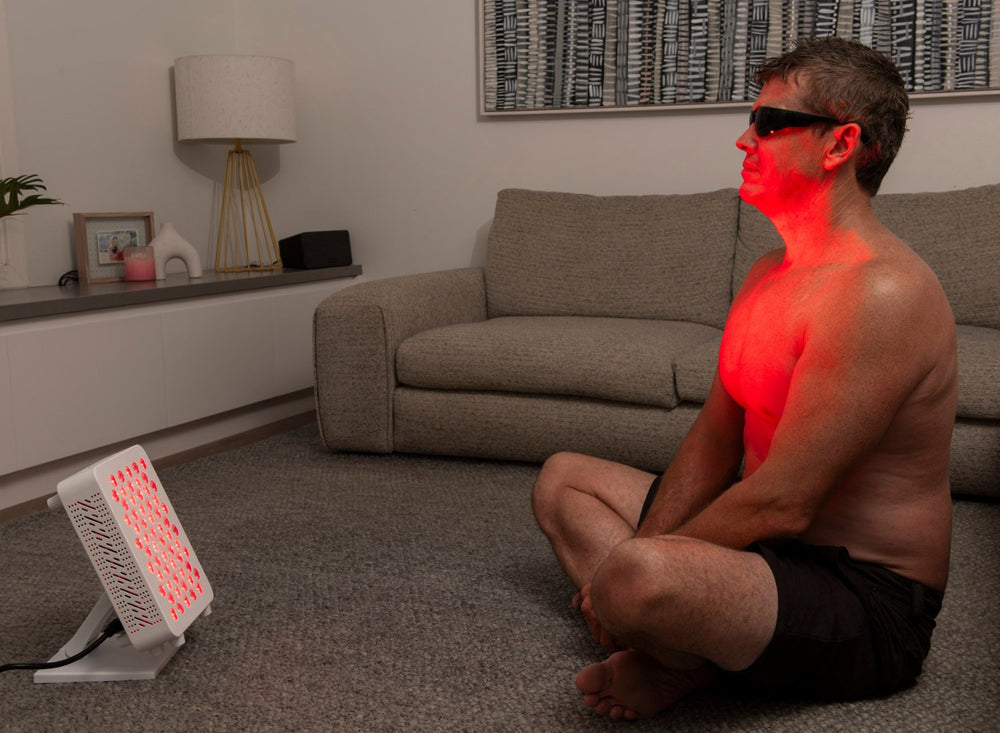 Baxter Blue Red Light Therapy Table Top_use on man in lounge room