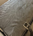 Textured mattress cover with brand tag on a bed