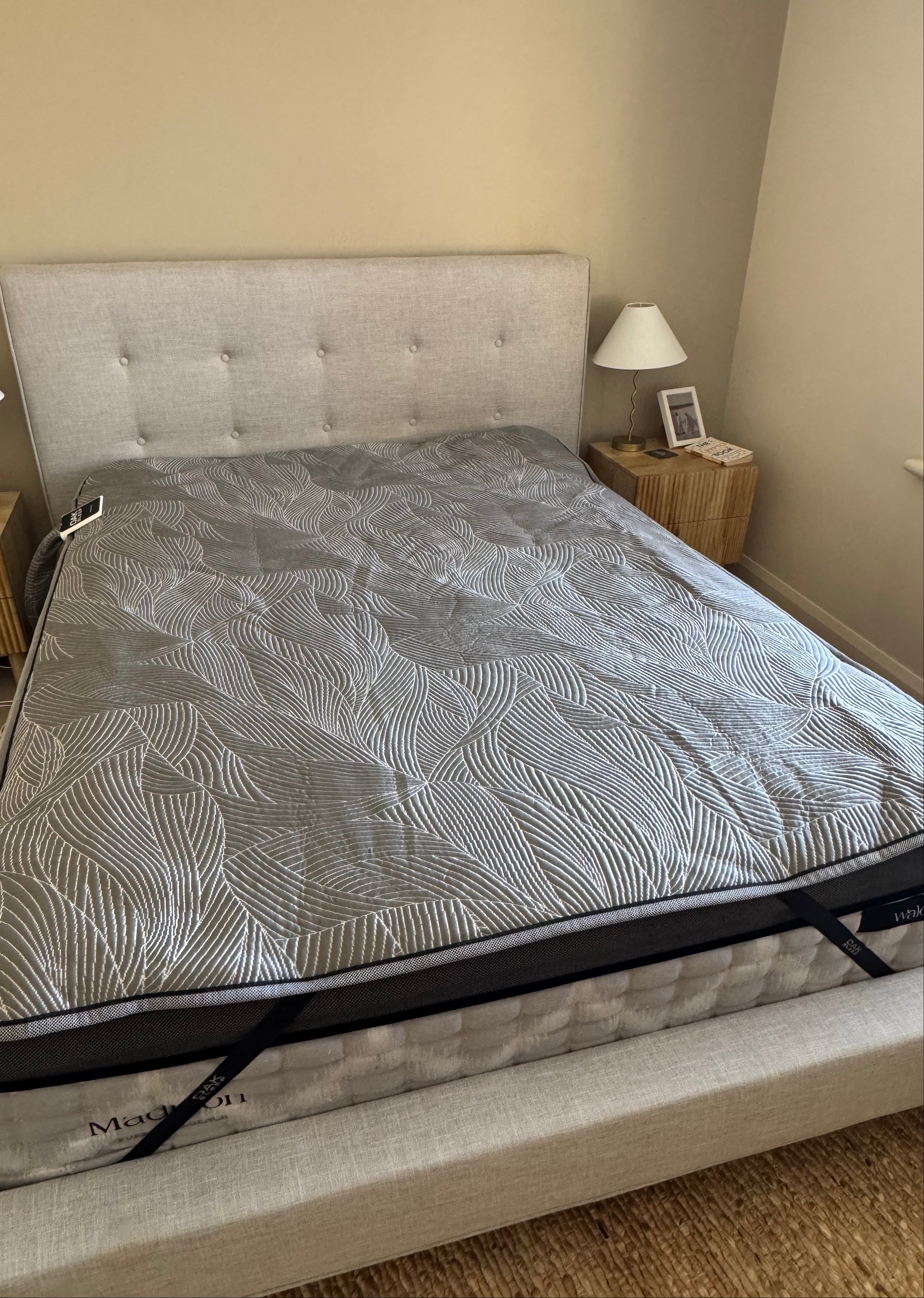 Bed with a OAK Sleep Hub 2 Queen mattress cover in a bedroom setting
