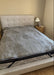 Bed with a OAK Sleep Hub 2 Queen mattress cover in a bedroom setting