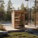 A 2-person outdoor traditional sauna shown in a natural setting