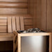Close-up of sauna heater with stones inside a 4-person indoor traditional sauna