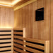 Close-up of a 4-person indoor infrared sauna interior with touchscreen control panel