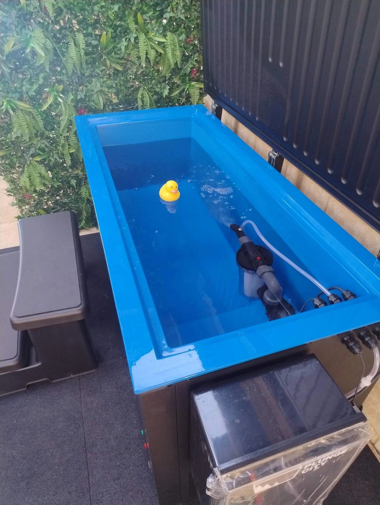 Plunge City Sub-Zero cold plunge ice bath filled with water in an outdoor setting
